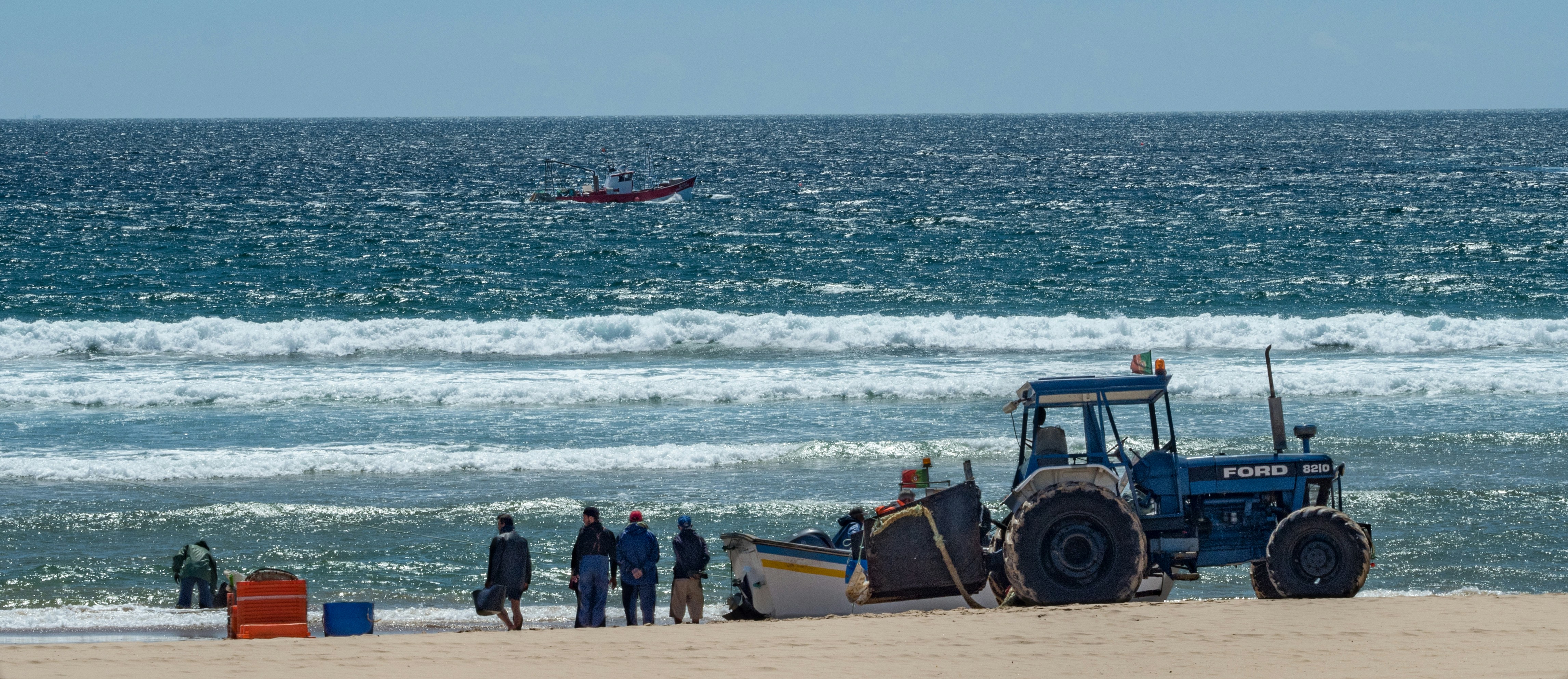 blue vehicle near ocean