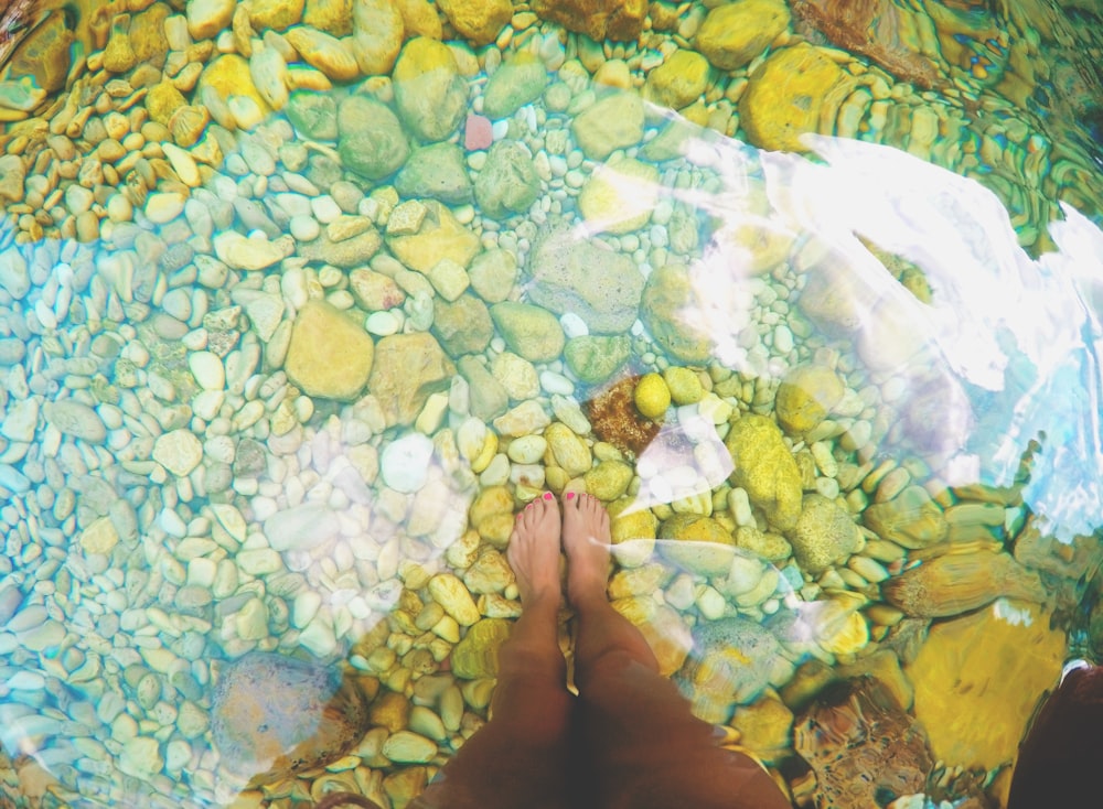 person standing on brown stones