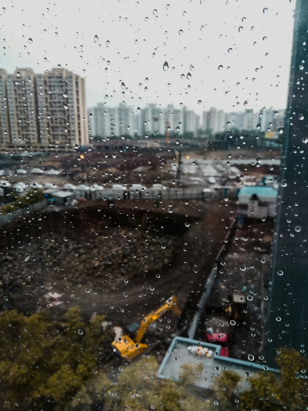 yellow excavator digging big hole at site in the city