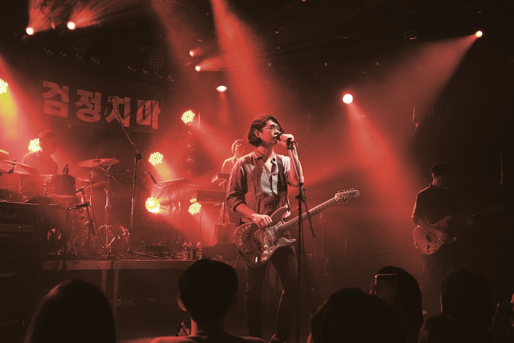 man singing performing on stage