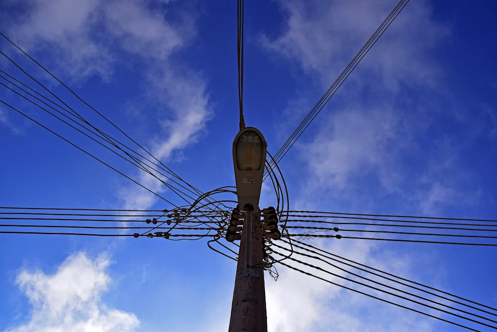 low angle photography of electric post during daytime