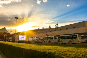 A lineup of various vehicles from swastik translink fleet under bright daylight