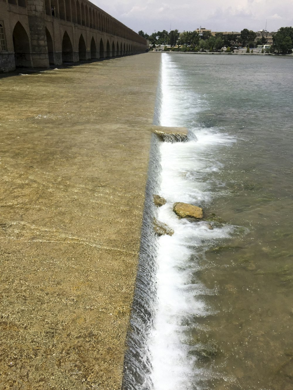 flowing body of water near bridge