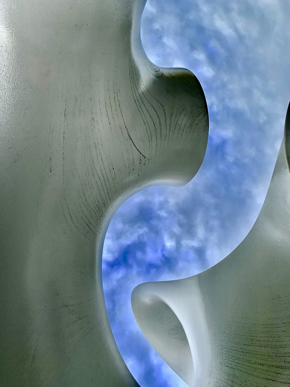 a white sculpture with a blue sky in the background