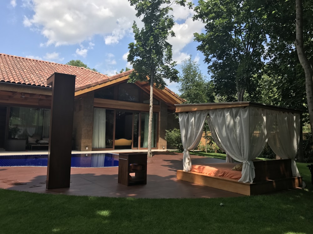 white canopy bed outside house