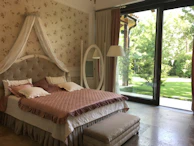 Elegant bedroom suite opening directly to a lush private garden.