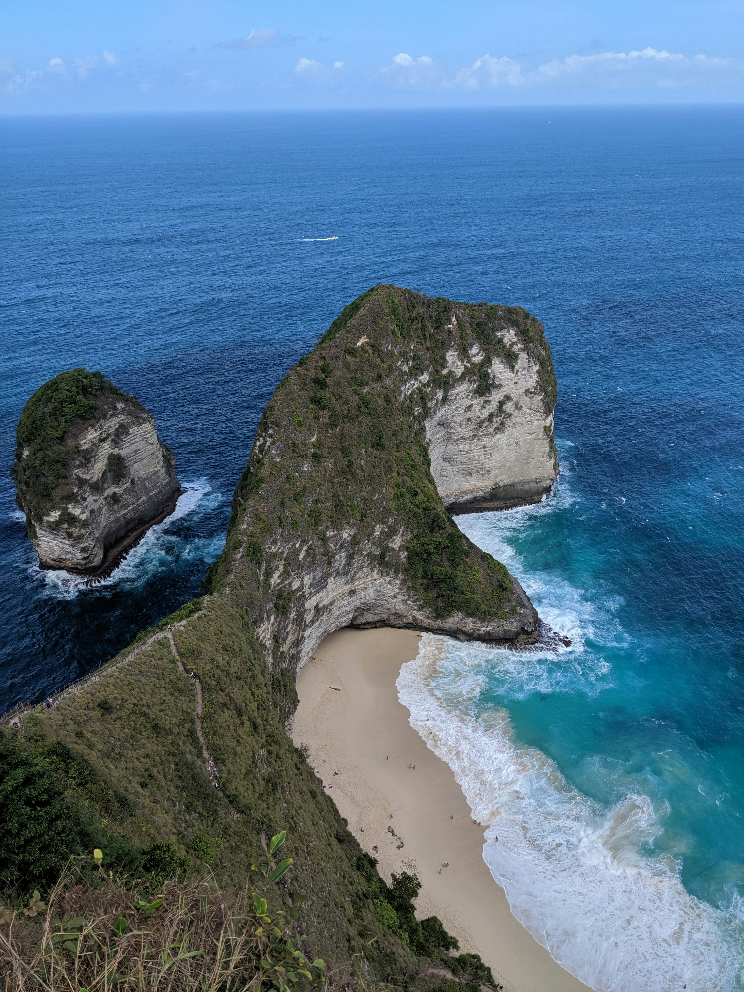 land mass beside body of water during daytime