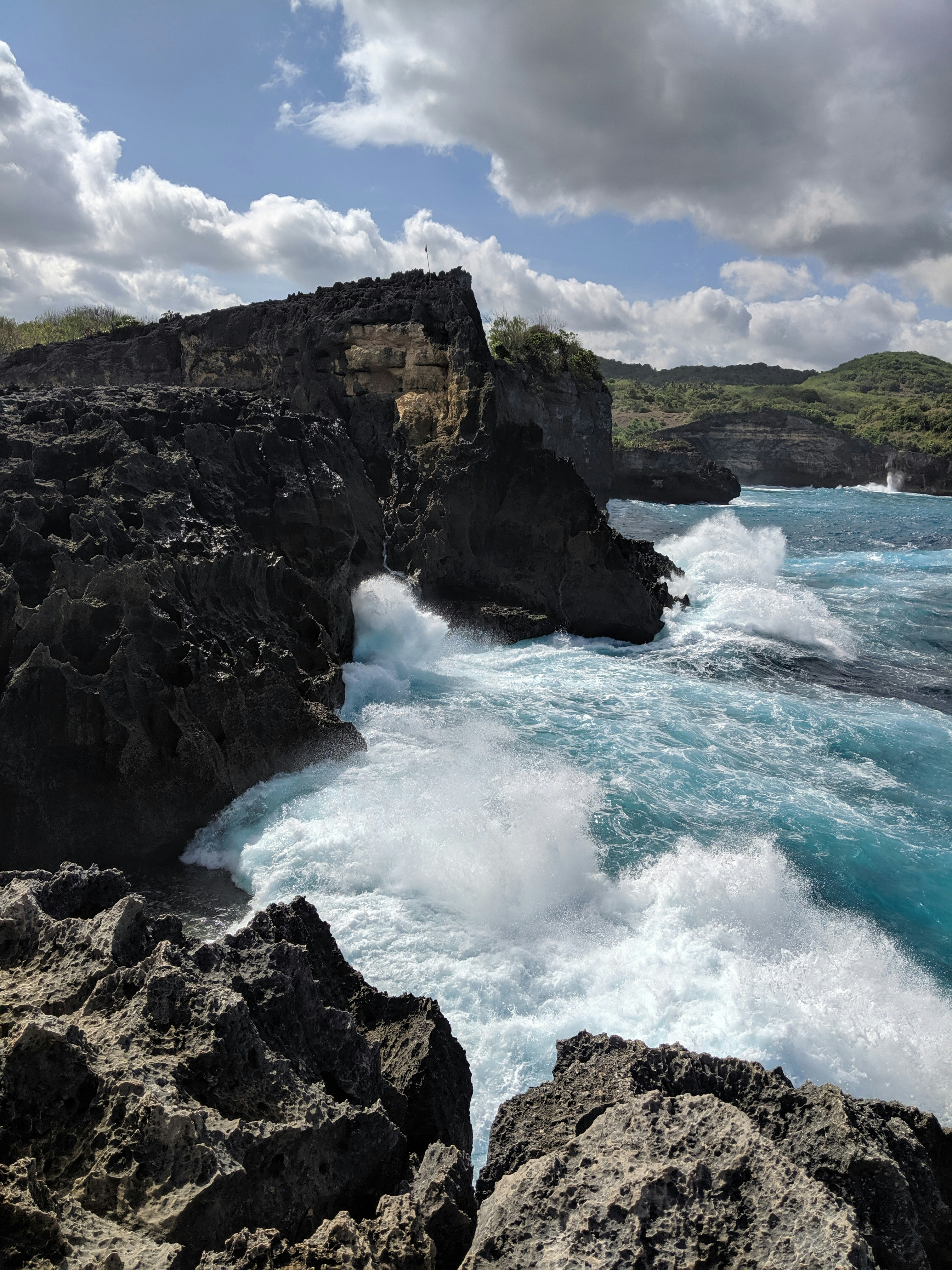 a large body of water near a rocky shore