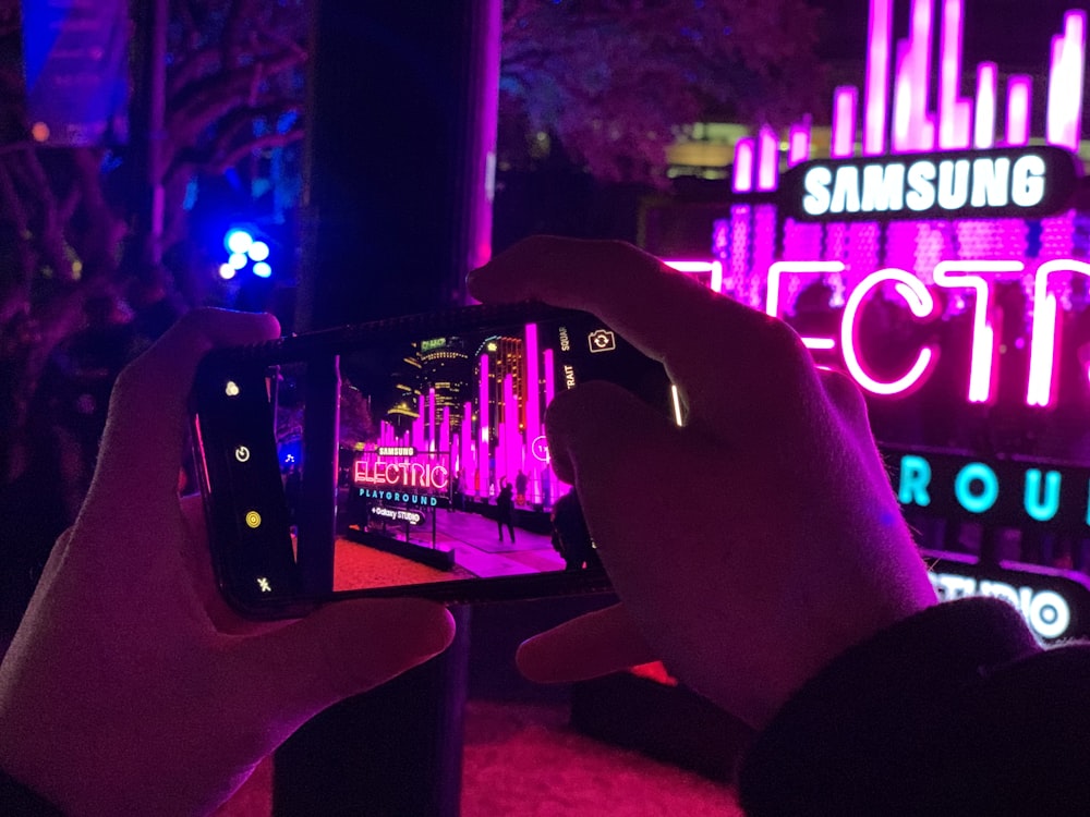 man taking photo in front of Samsung store