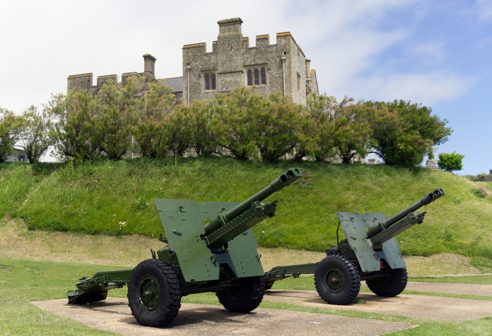 two green and gray machine guns near gray chateau