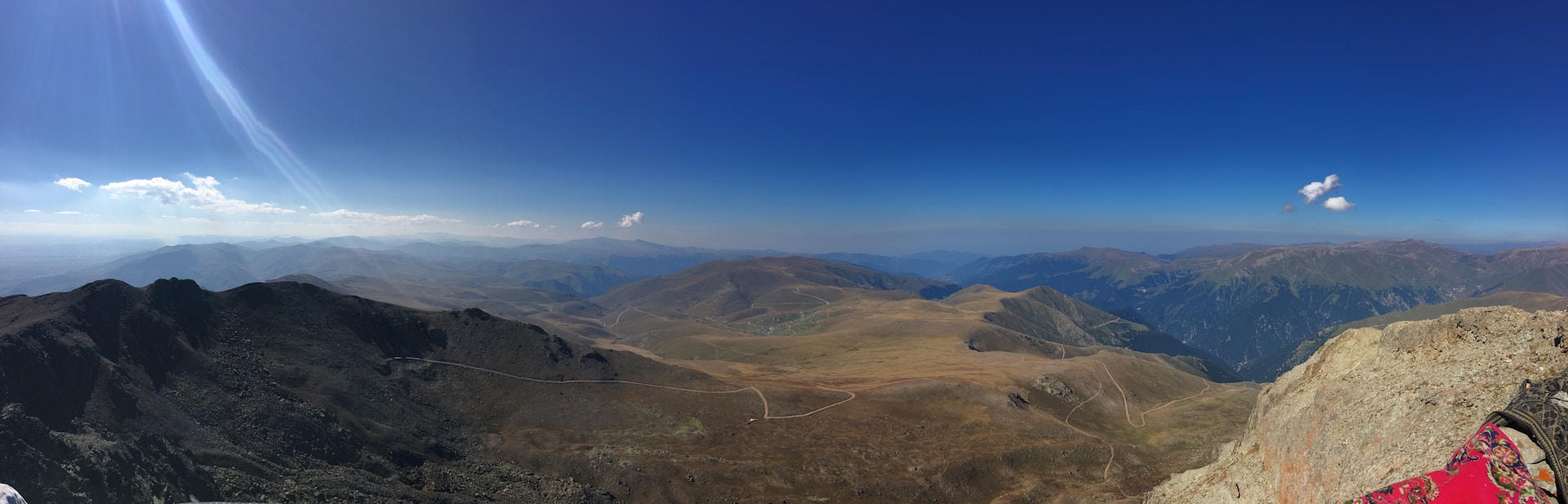 woman wearing yellow long-sleeved dress under white clouds and blue sky during daytime