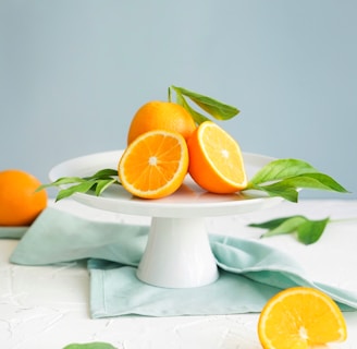 orange fruit in white ceramic plate close-up photography