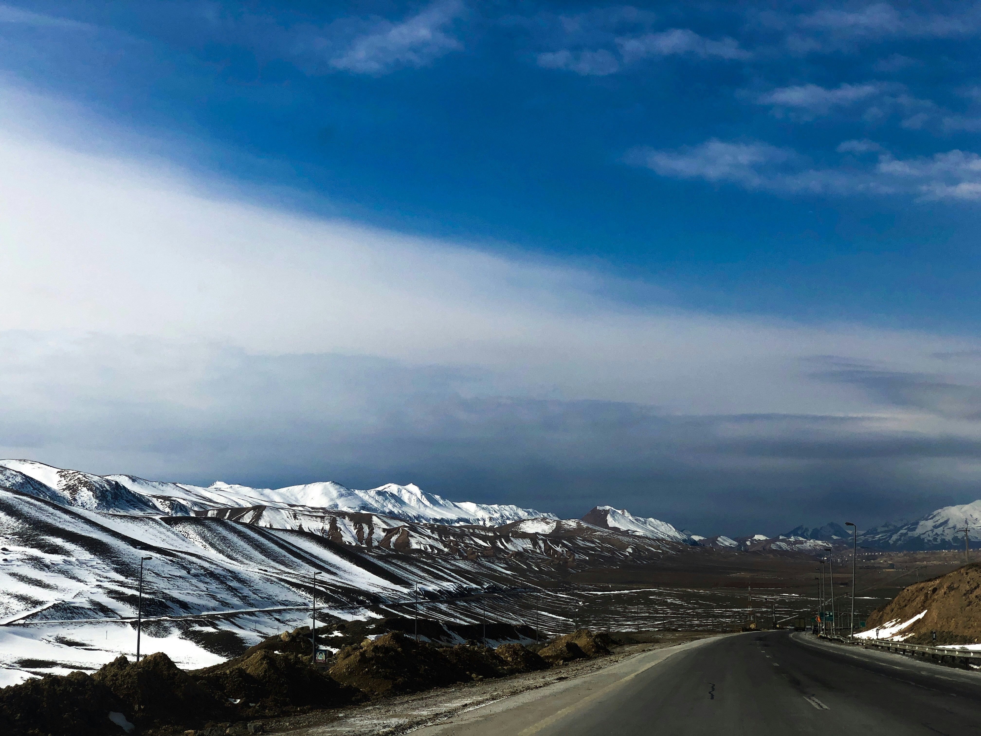 icy mountain and gray asphalt road