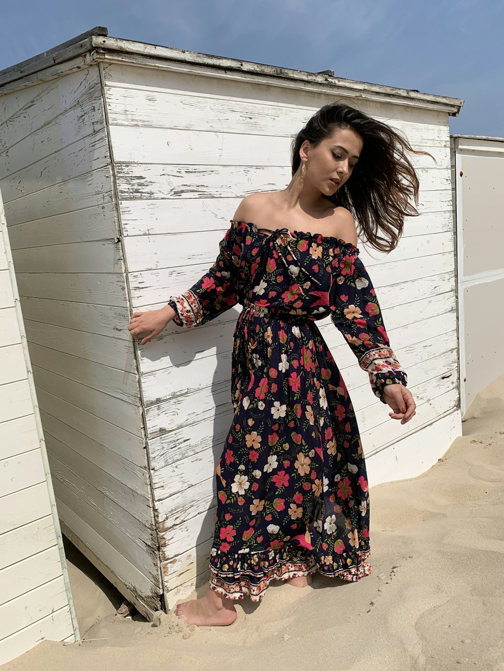 woman wearing red and black floral off-shoulder dress