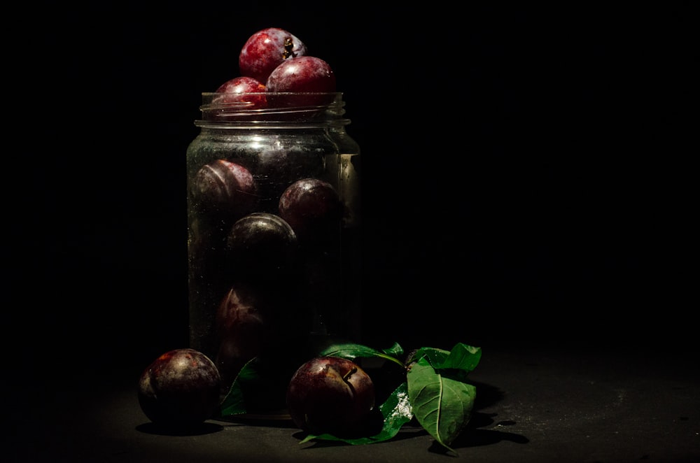 clear glass jar with red fruits