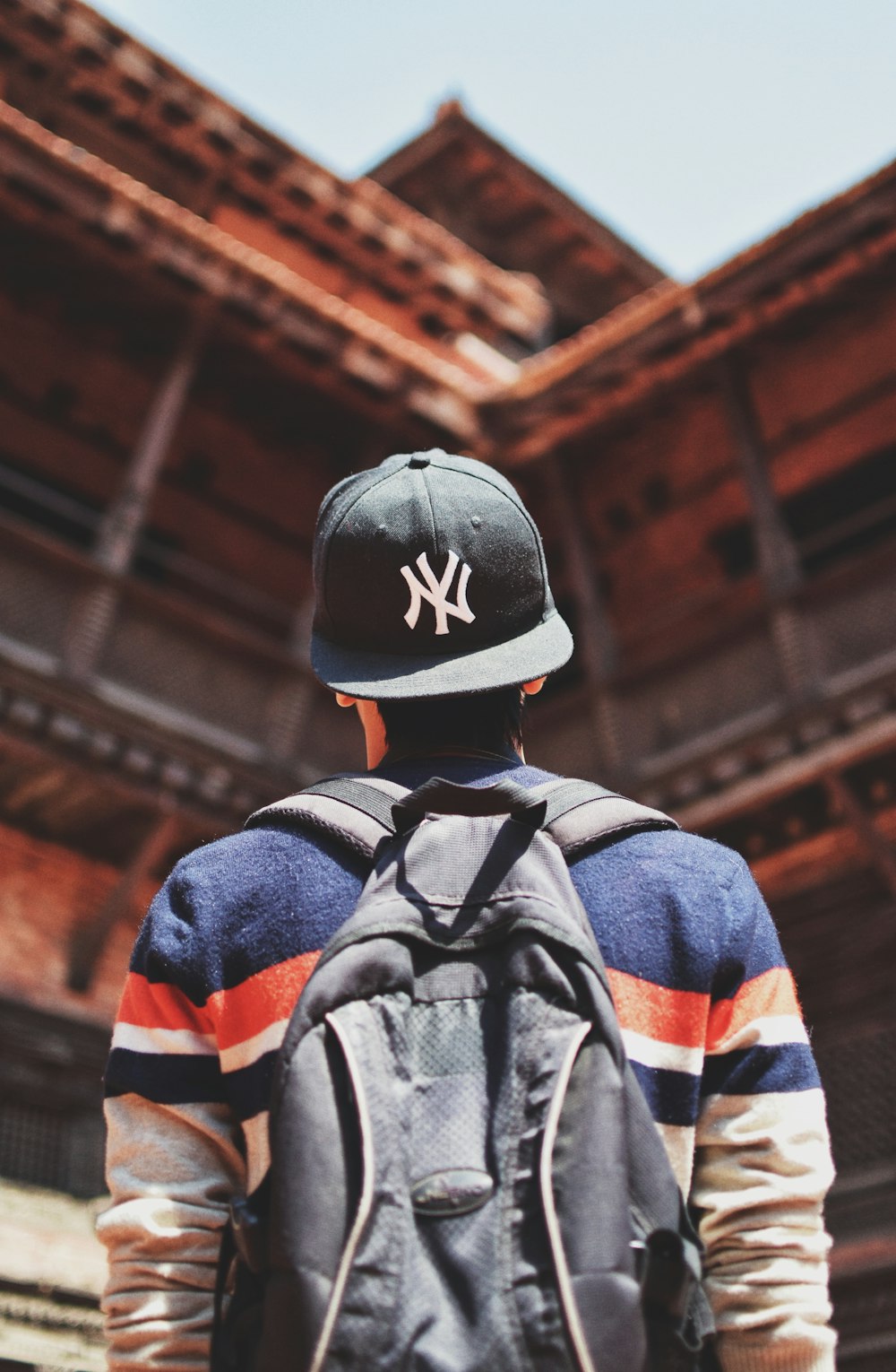 selective focus photography of man facing on building during daytime