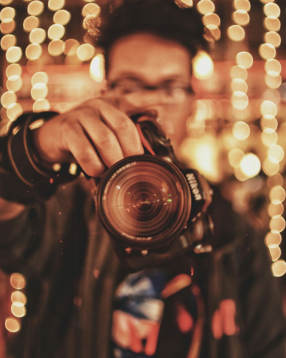 person holding black Nikon DSLR camera