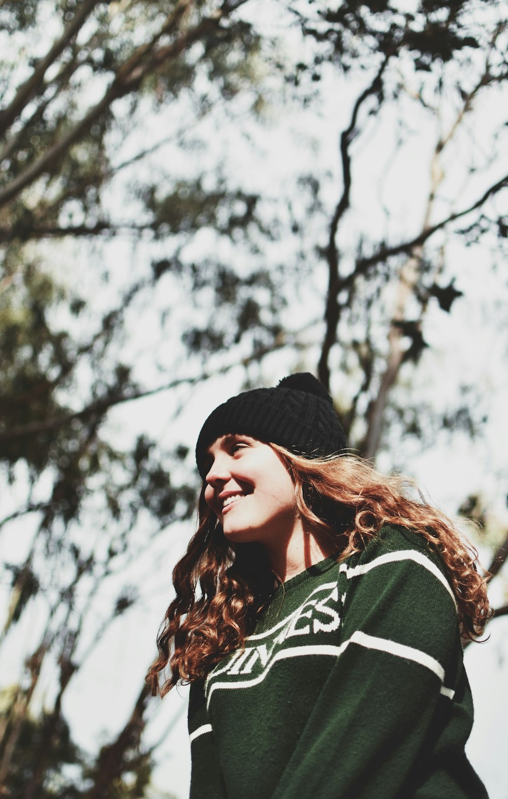 woman wearing green and white long-sleeved shirt