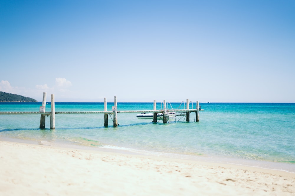 white boardwalk on body of water