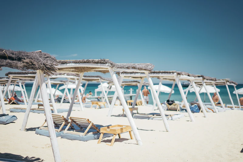 Chic beach club loungers and parasols on the sand near Saint-Tropez