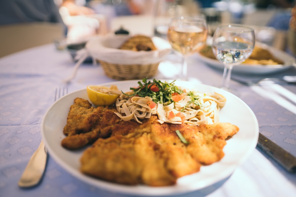 round white ceramic plate with fried foods