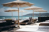brown wooden sunloungers on beach