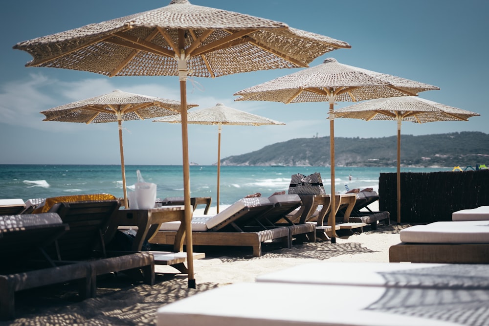 brown wooden sunloungers on beach