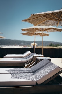 white outdoor lounges with umbrellas