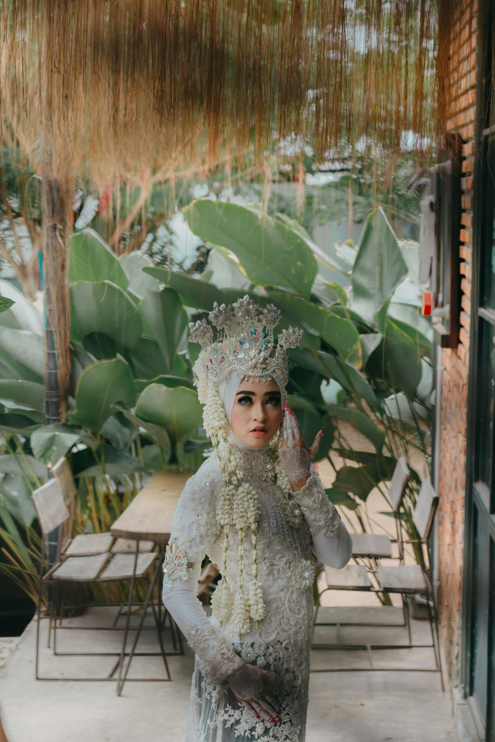 woman in white long-sleeved dress standing near door