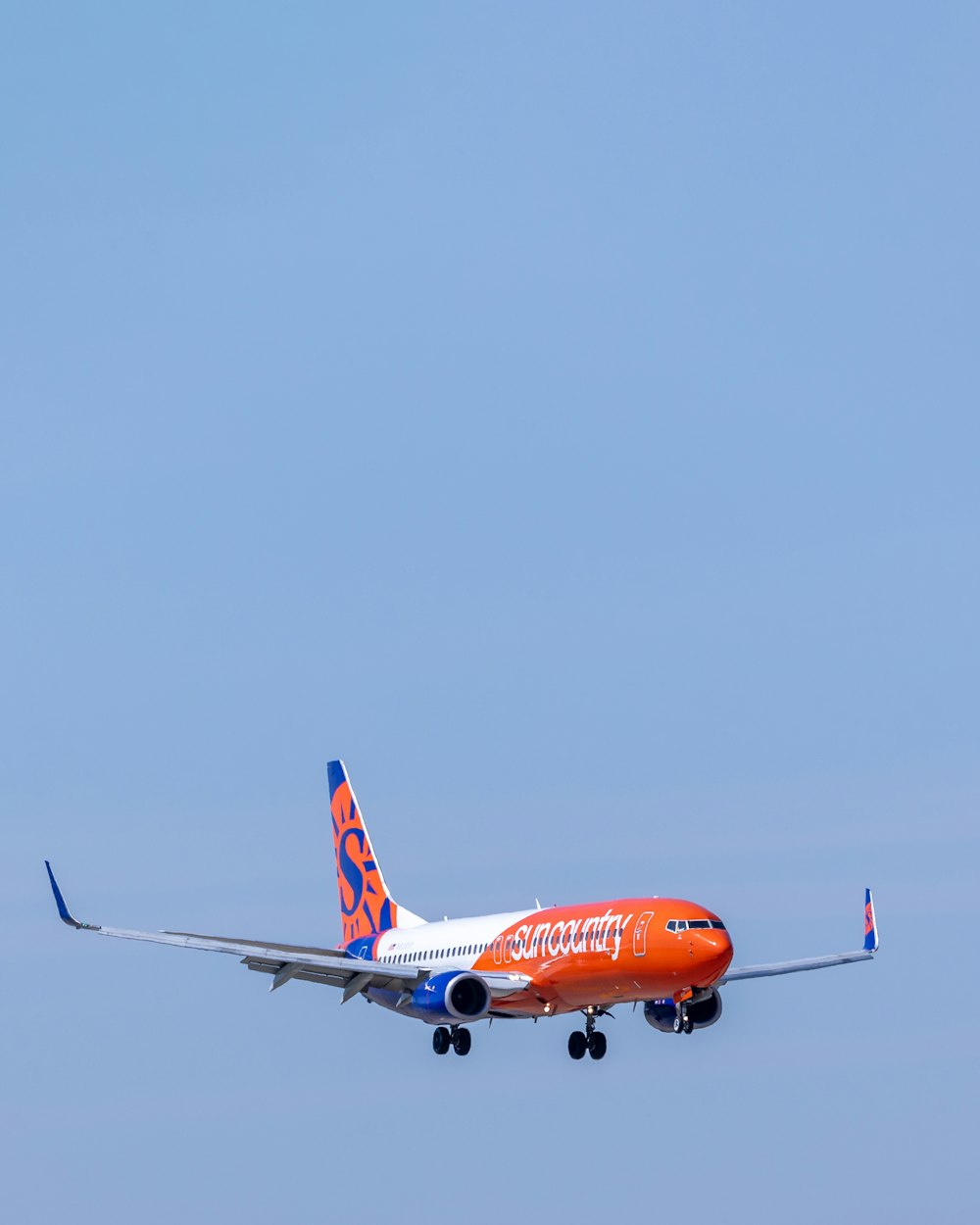 orange and white airplane on flight