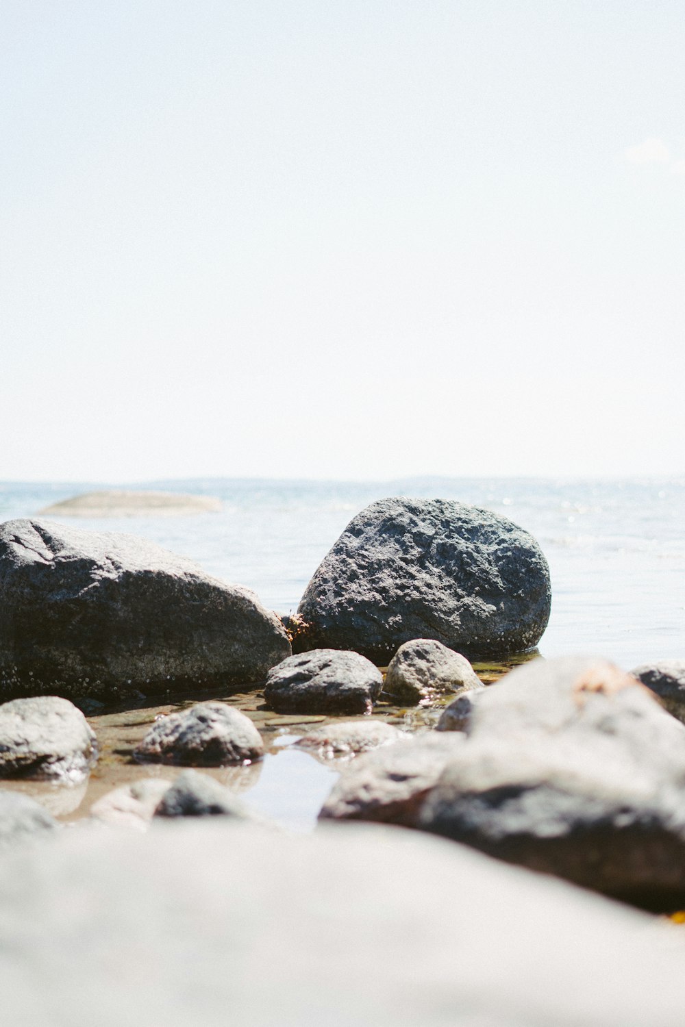 stone beside body of water during daytime