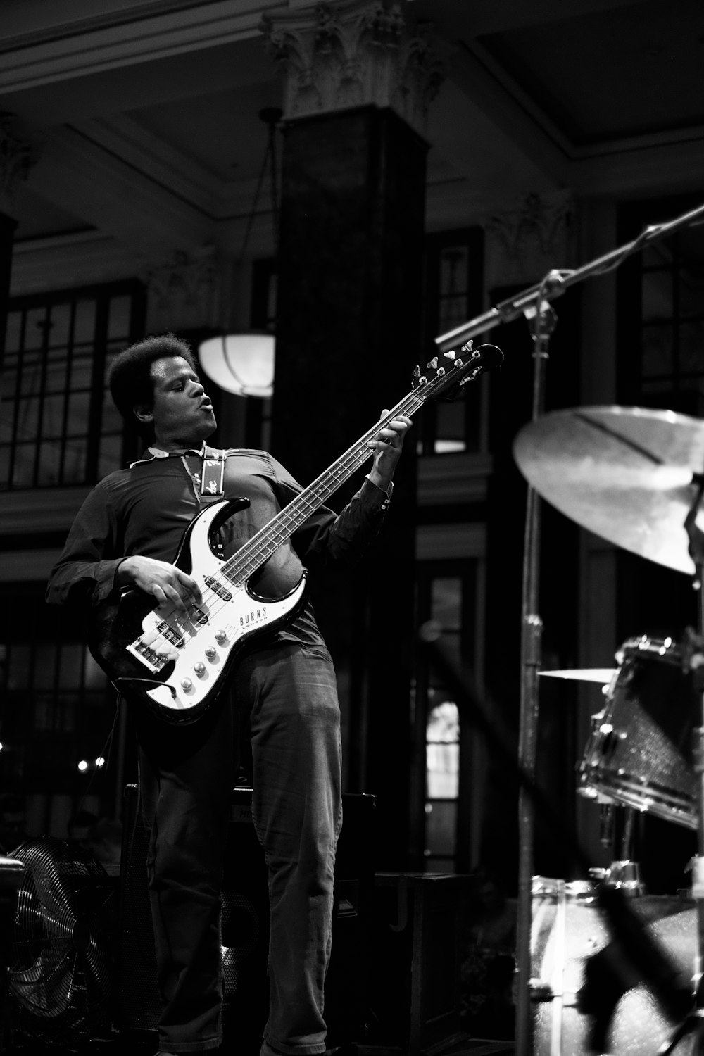 man playing electric guitar at the stage