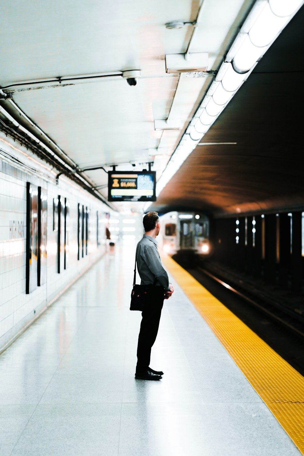 man standing at the train station