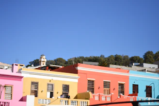 A vibrant street in Agra showing newly built sustainable homes with clean lines and orange accents.