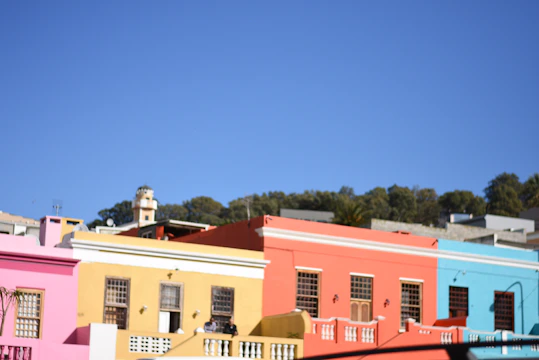 A vibrant street in Agra showing newly built sustainable homes with clean lines and orange accents.