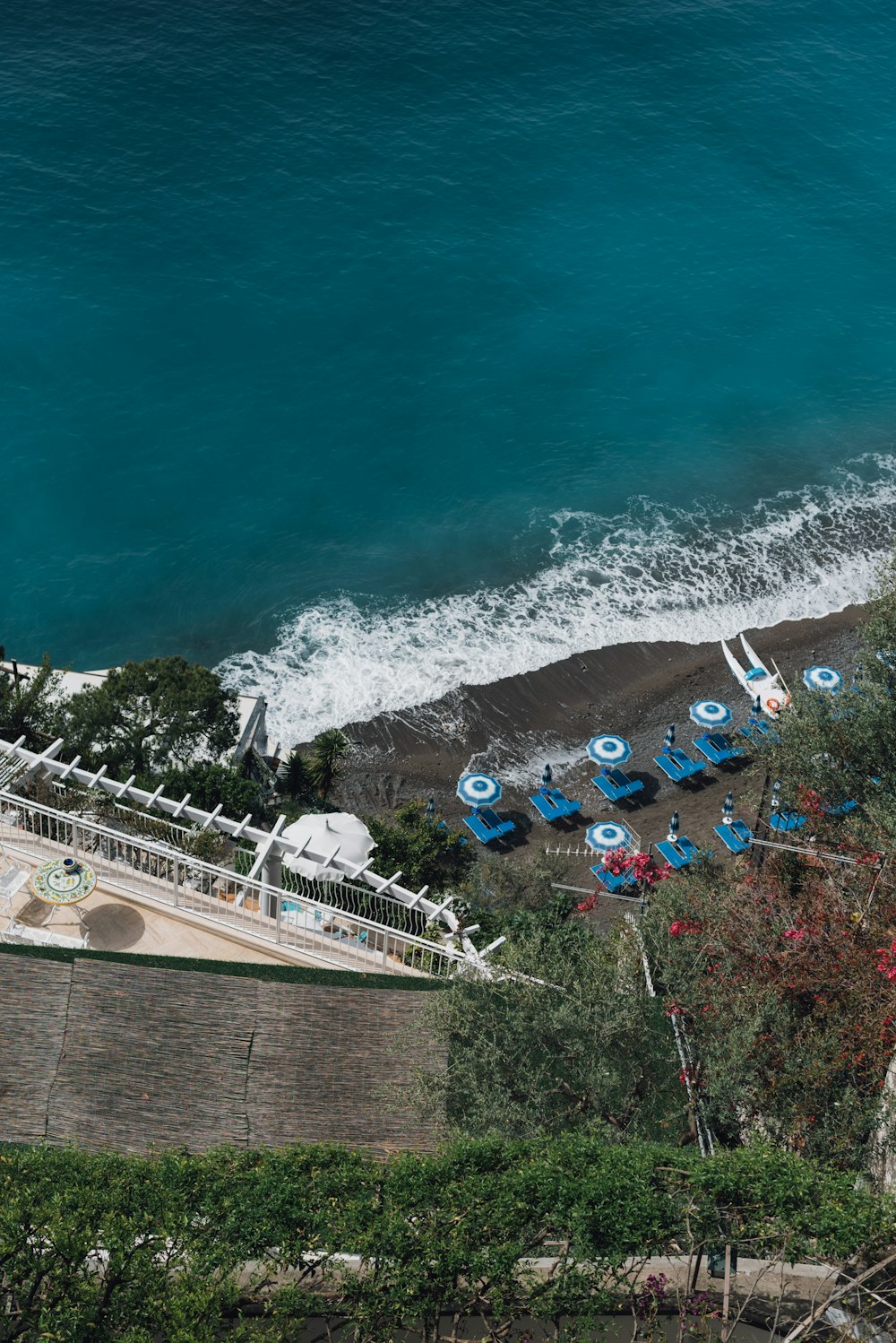 aerial photography of umbrellas and sunloungers by the beach