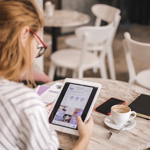 woman holding white iPad