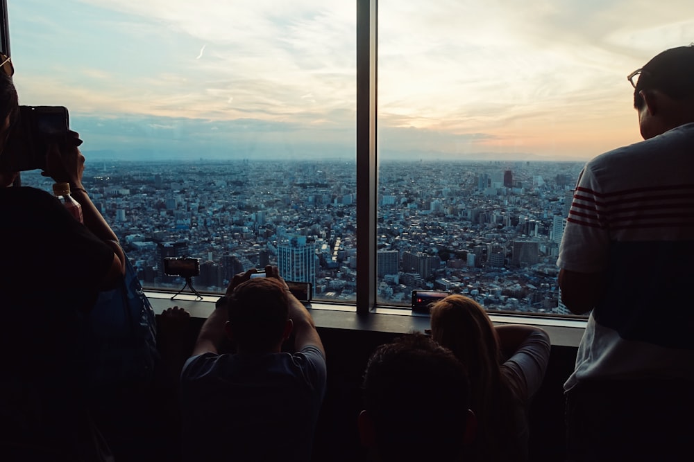 people looking down through high-rise buildings