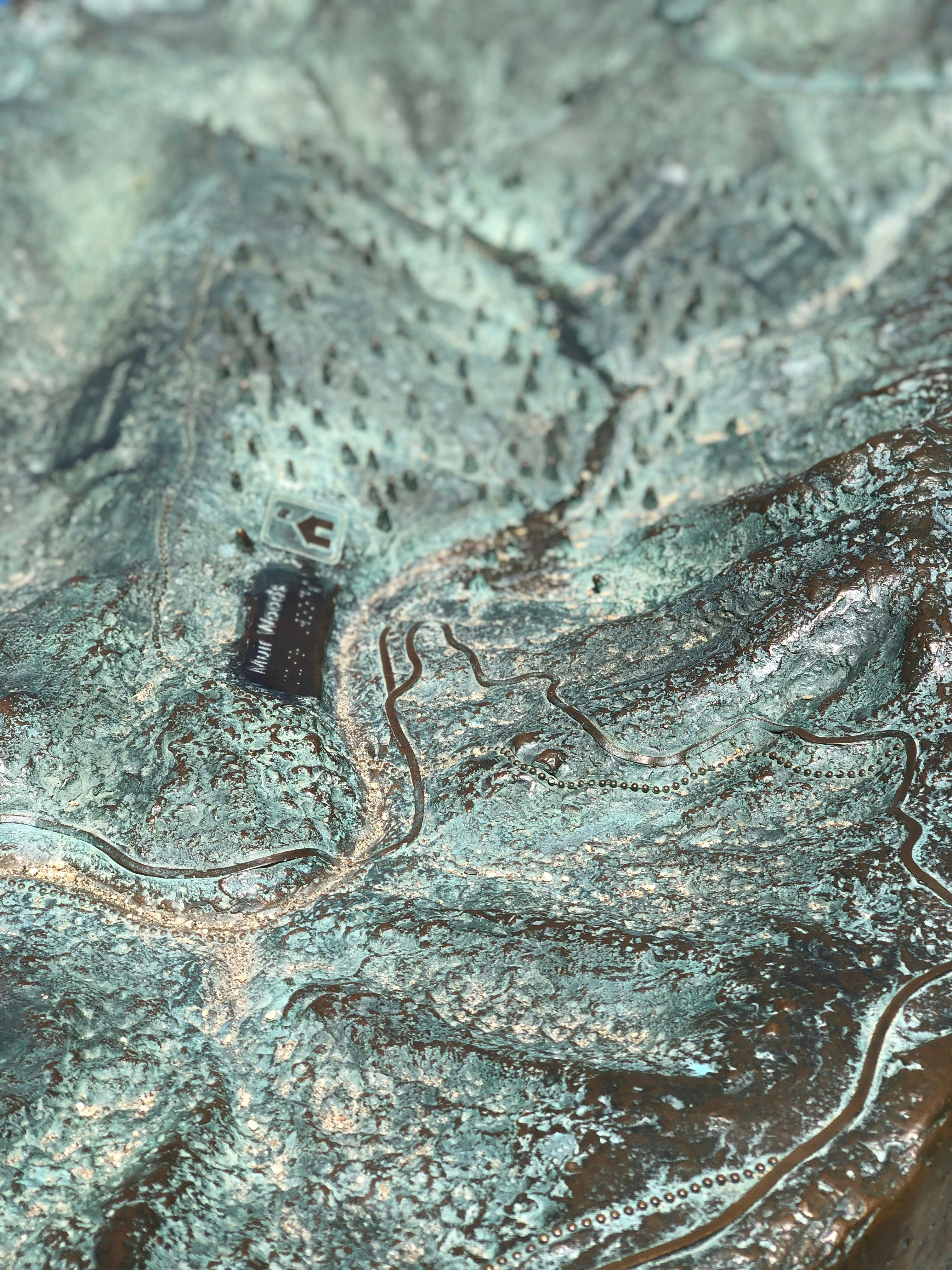 a close up of a metal surface with a small object on it