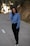 woman wearing blue sweatshirt and black straight-cut jeans \