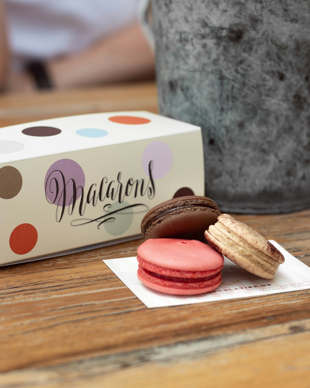 three macarons near box