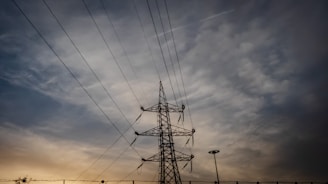 silhouette photo of black transmission tower