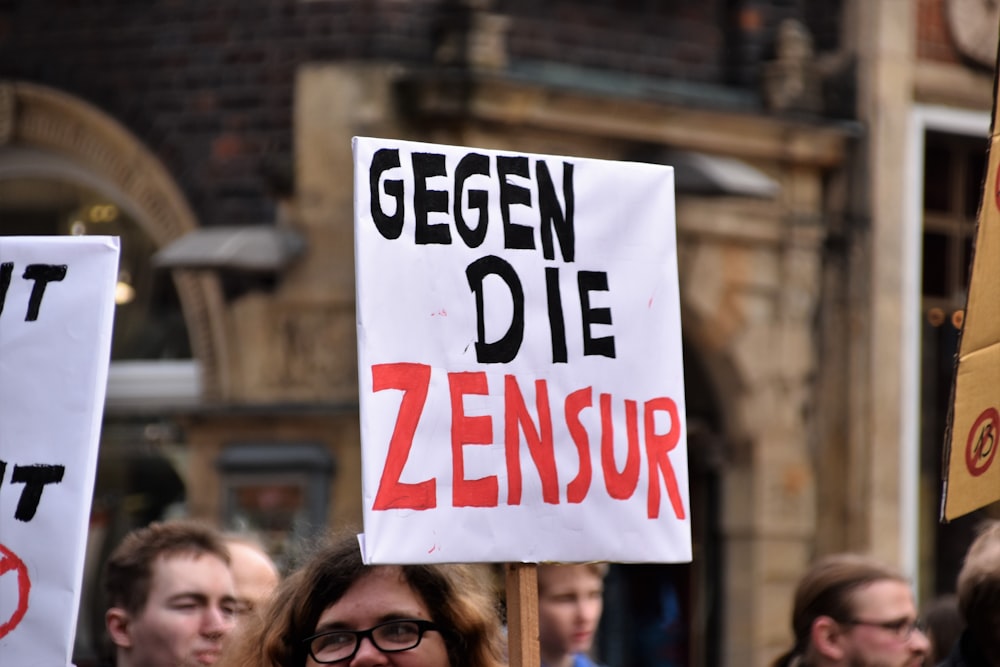 person holding gegen die zensur signage