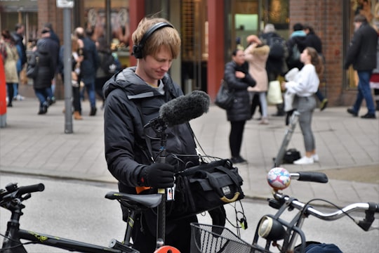 man holding black camera microphone in Mönckebergstraße 16 Germany