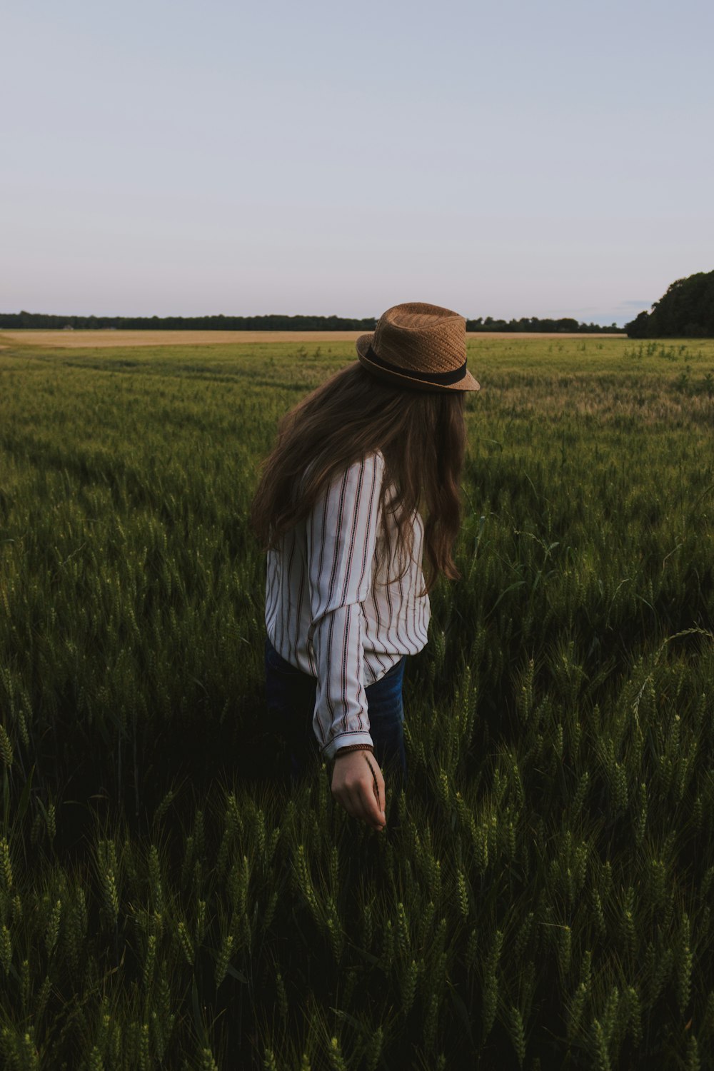 person standing on green field