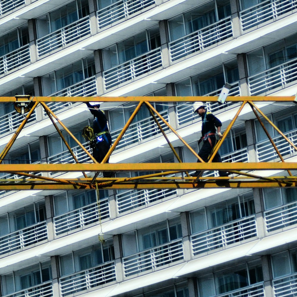 men at work on metal crane