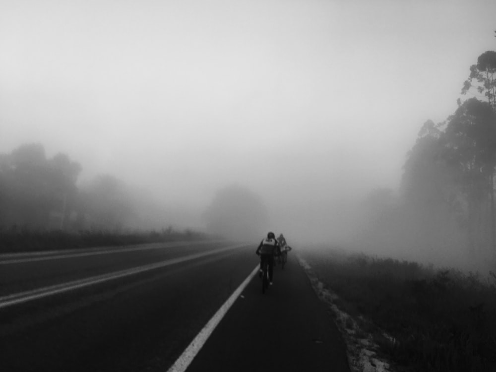 people riding on bike covered in fog