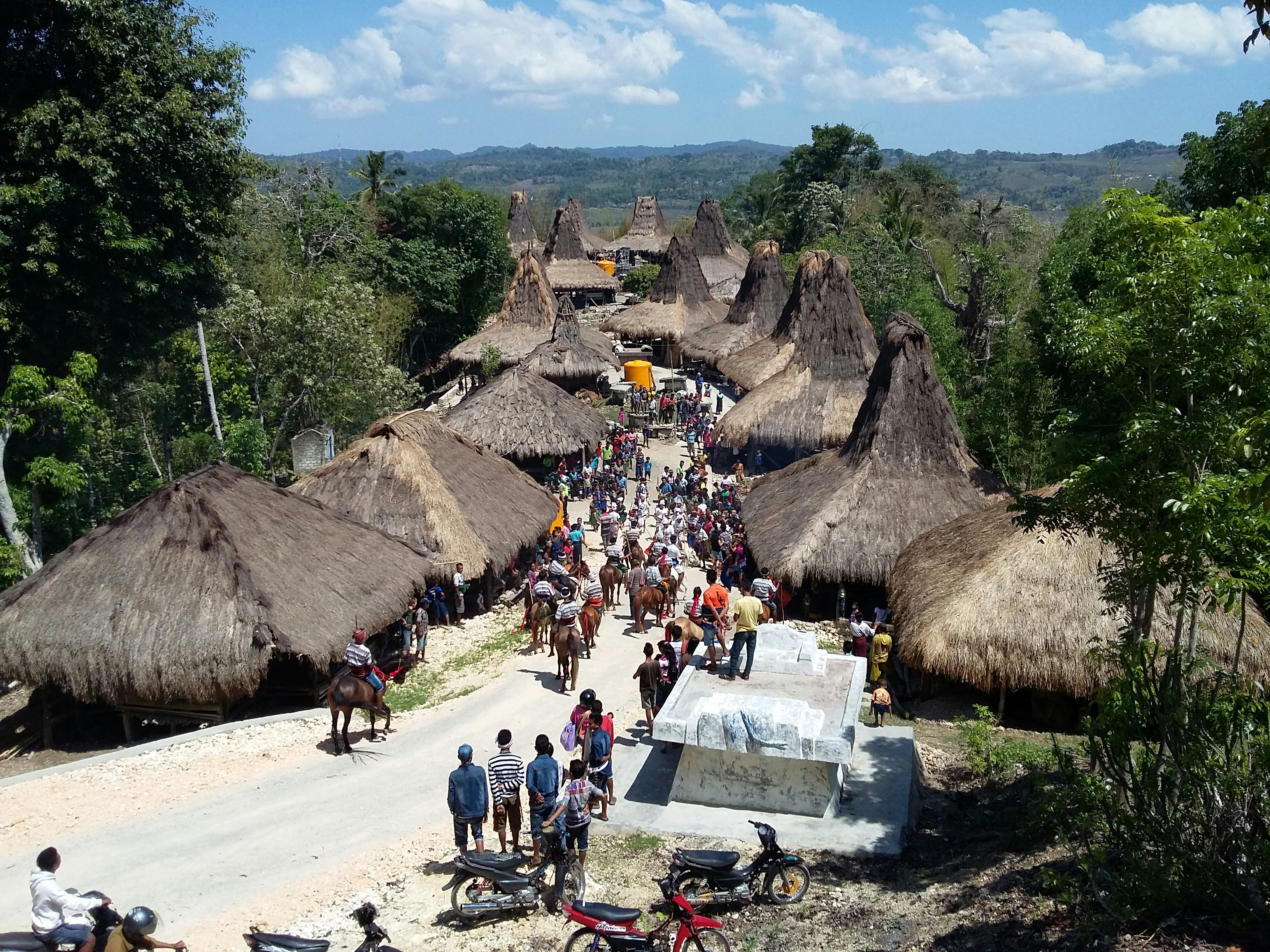 people gathering near the hut lot during daytime