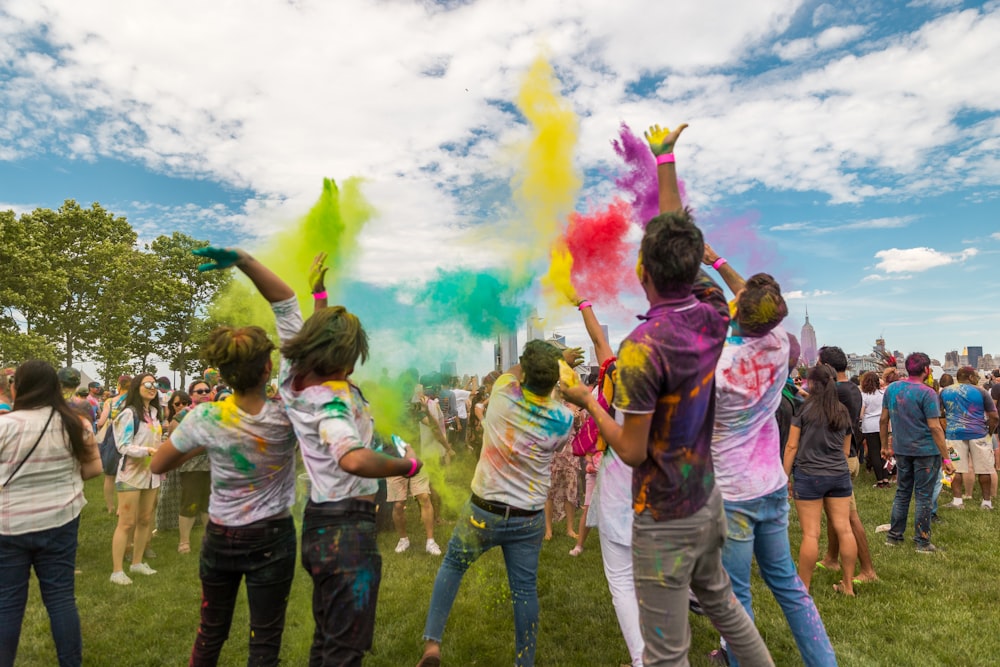 people throwing colored powders