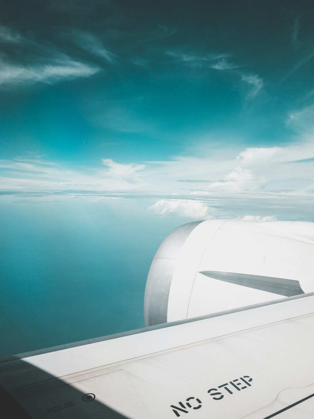 white airliner flying on sky